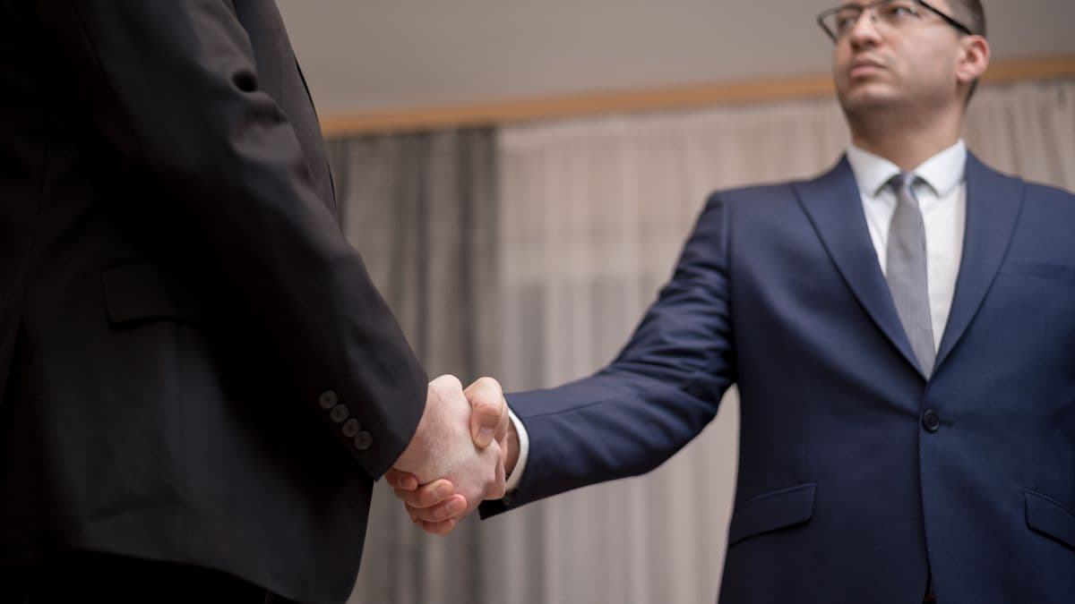 Conveyancer comparing search provider options at a desk with documents