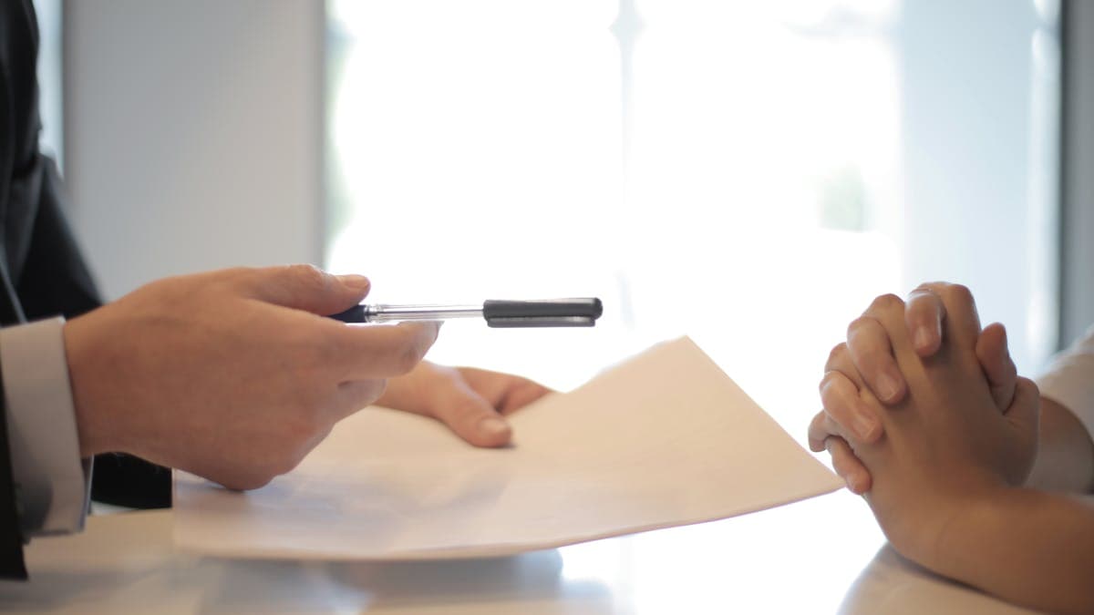 Insurance policy documents and a property search report on a desk, representing professional indemnity cover for a search firm
