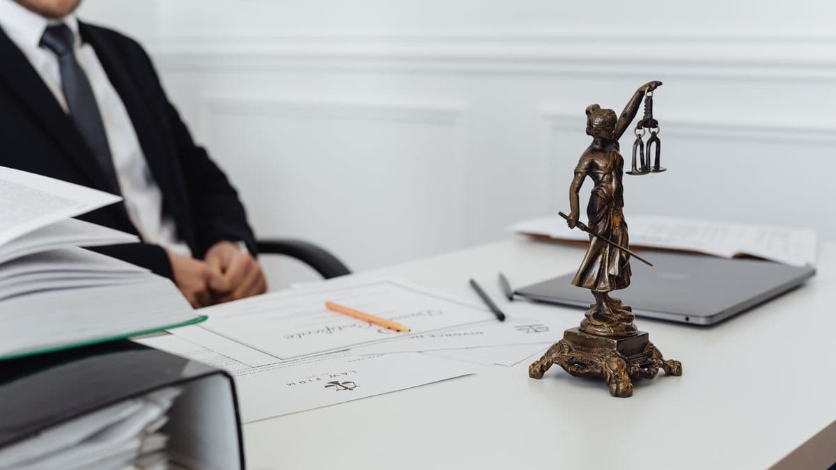 Person reviewing a written complaints letter at an office desk, representing consumer redress