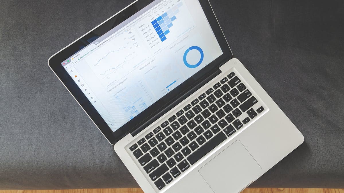 Personal search company back office desk with property search documents and laptop