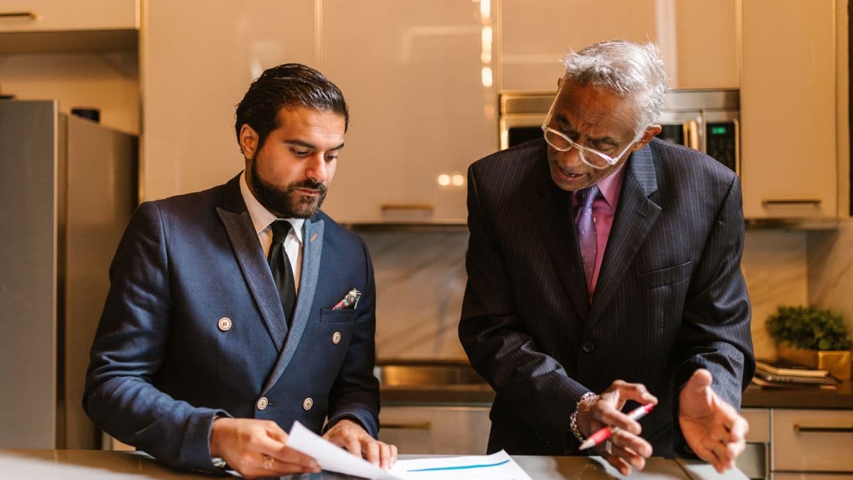 Two search firm professionals reviewing a map and order screen together