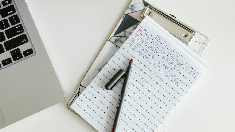 Mortgage paperwork and a house key on a desk, representing lender search requirements
