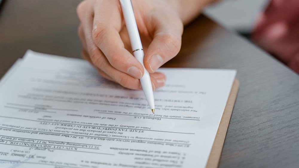 A person verifying identity on a tablet for a property transaction
