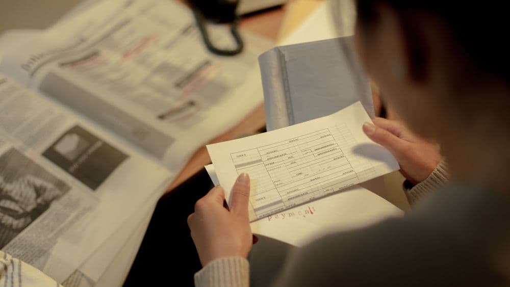 Property search documents and a planning map spread across a desk