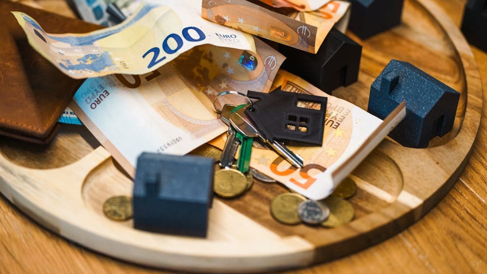 House keys and miniature houses representing a property purchase