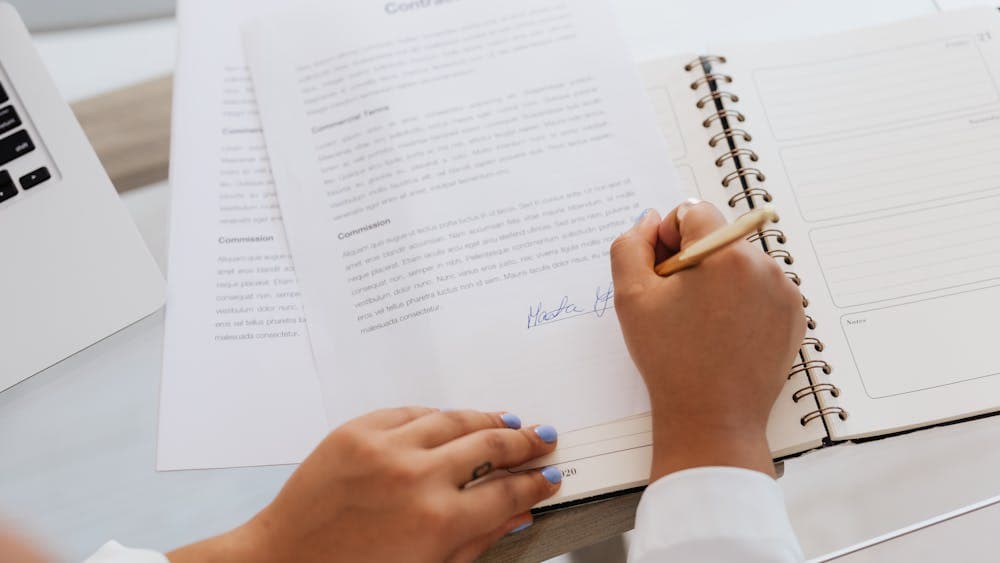 Person reading a formal letter at a desk