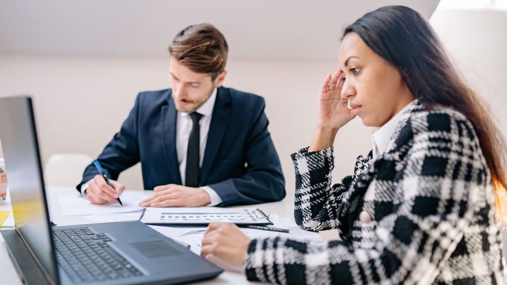 A search-firm team working through orders at a desk