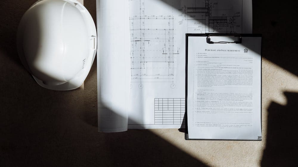 Two property search documents laid side by side for comparison on a desk