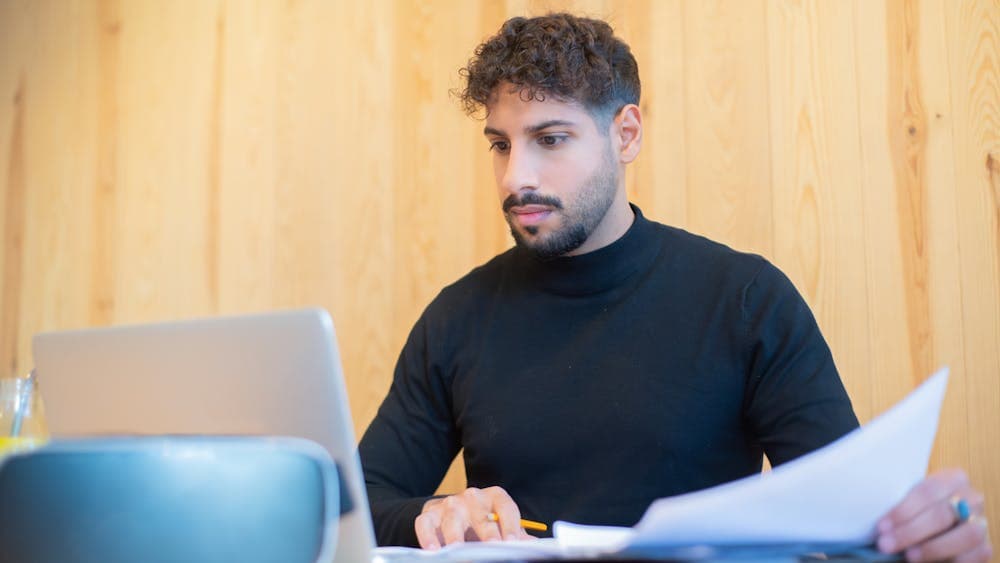 A search-firm processor working through property documents on a laptop